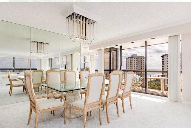 dining room featuring an inviting chandelier, a textured ceiling, and light colored carpet