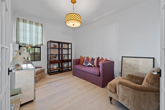 living area with crown molding and light wood-type flooring