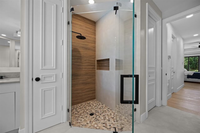 bathroom featuring walk in shower, ceiling fan, tile flooring, and vanity