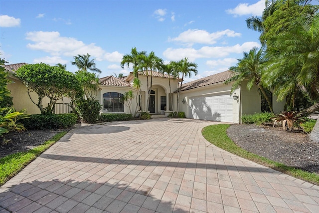 mediterranean / spanish-style home featuring a garage