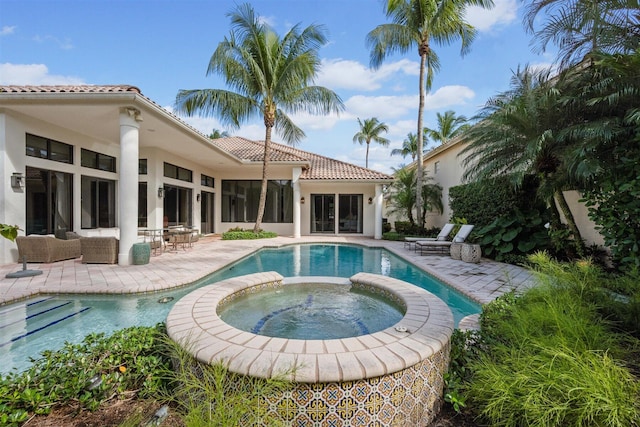 view of pool with an in ground hot tub and a patio area