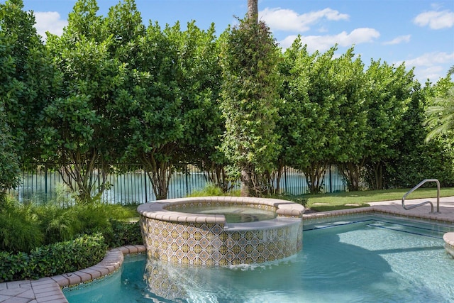 view of swimming pool featuring an in ground hot tub