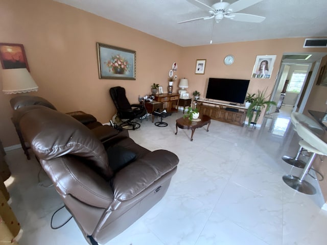 living room with ceiling fan and light tile floors