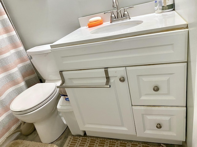 bathroom featuring vanity, tile flooring, and toilet