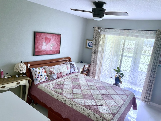 bedroom with a textured ceiling and ceiling fan