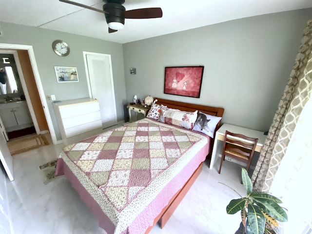 bedroom featuring ensuite bath and ceiling fan