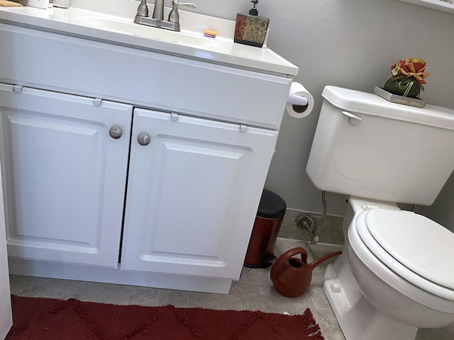 bathroom with vanity, tile floors, and toilet