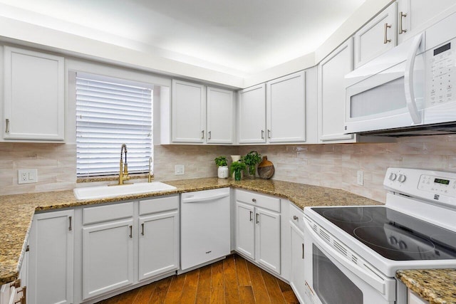 kitchen featuring white appliances, sink, backsplash, dark hardwood / wood-style flooring, and white cabinetry