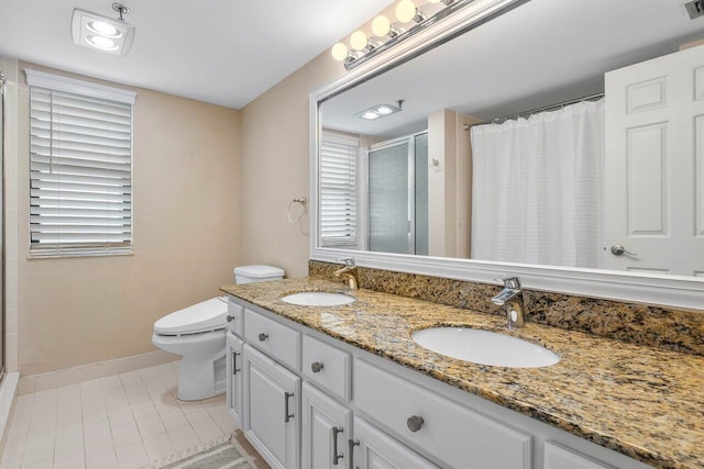 bathroom with vanity, toilet, walk in shower, and tile patterned flooring