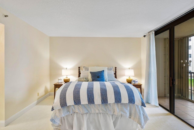 carpeted bedroom featuring a textured ceiling