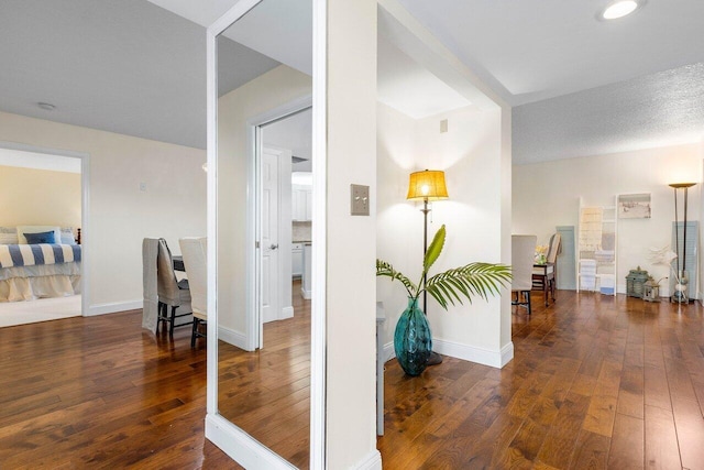 hallway with dark hardwood / wood-style flooring