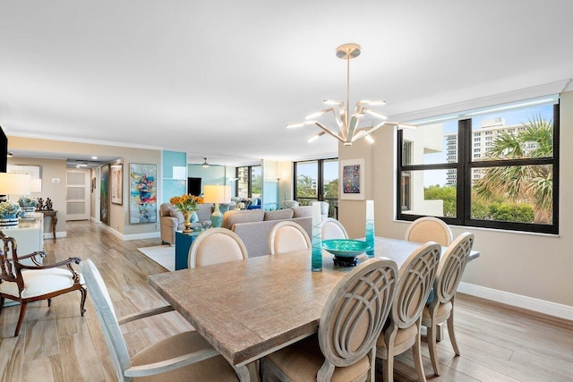 dining area featuring light hardwood / wood-style floors and a notable chandelier