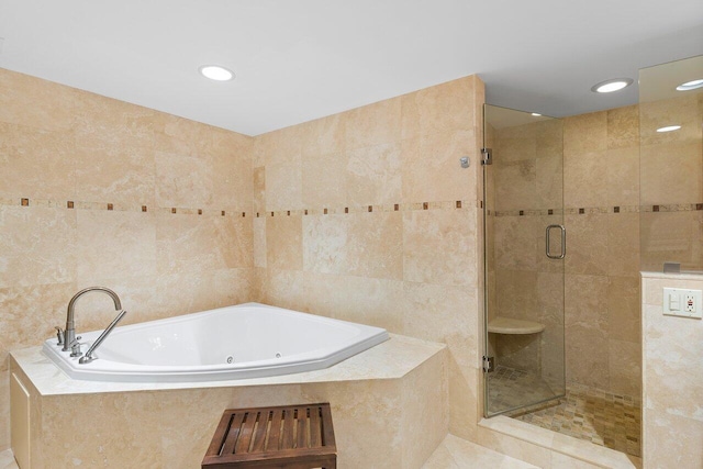 bathroom with tile walls, tile patterned flooring, and separate shower and tub