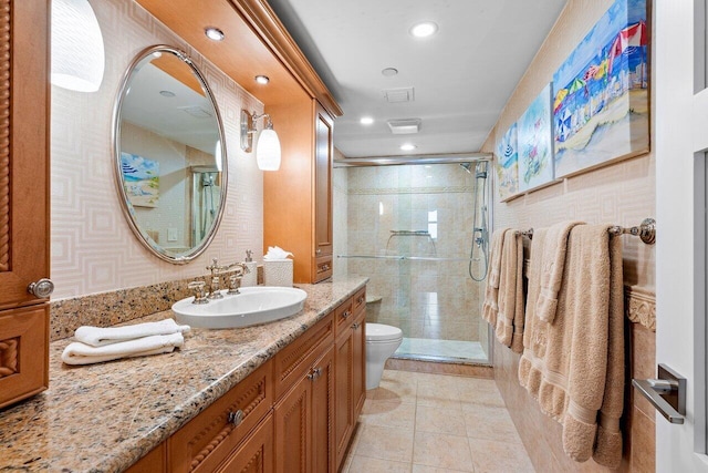 bathroom with tile patterned floors, an enclosed shower, vanity, and toilet