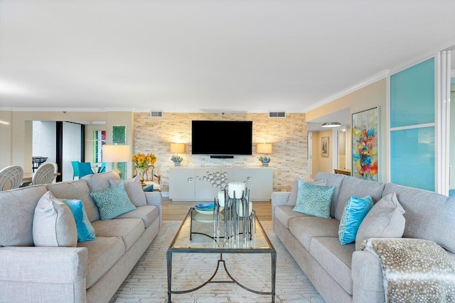 living room with light hardwood / wood-style floors and crown molding