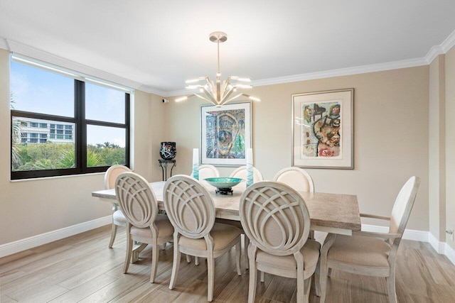 dining area featuring a chandelier, ornamental molding, and light wood-type flooring