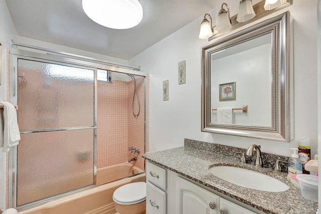 full bathroom with shower / bath combination with glass door, vanity, and toilet