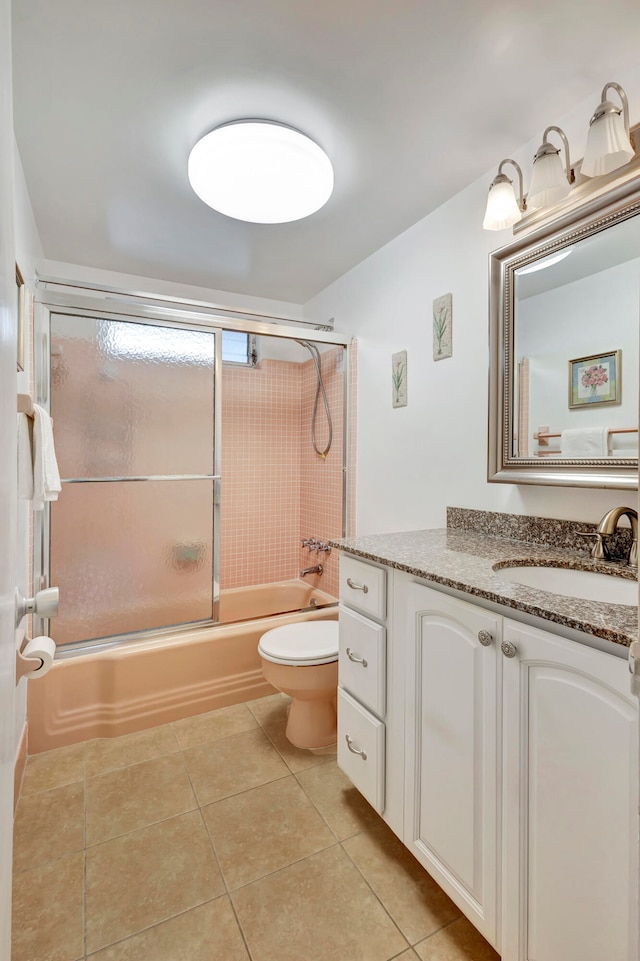 full bathroom with tile patterned floors, vanity, toilet, and enclosed tub / shower combo