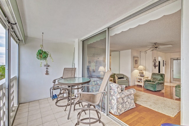 sunroom / solarium featuring ceiling fan