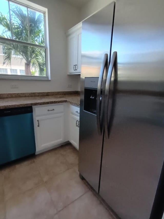 kitchen featuring stainless steel appliances, white cabinetry, and light tile floors