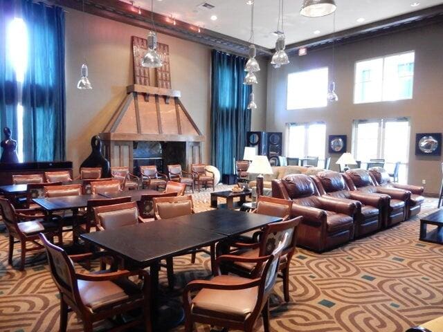 carpeted dining area featuring a high ceiling