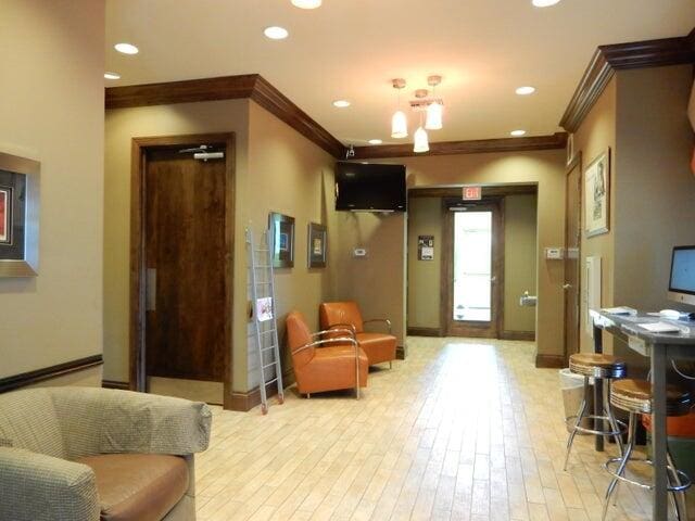 living area featuring ornamental molding and light wood-type flooring