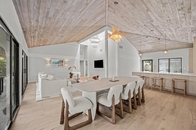 dining space featuring high vaulted ceiling, wood ceiling, and light hardwood / wood-style floors