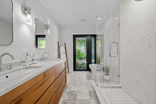 bathroom featuring vanity, toilet, and an enclosed shower