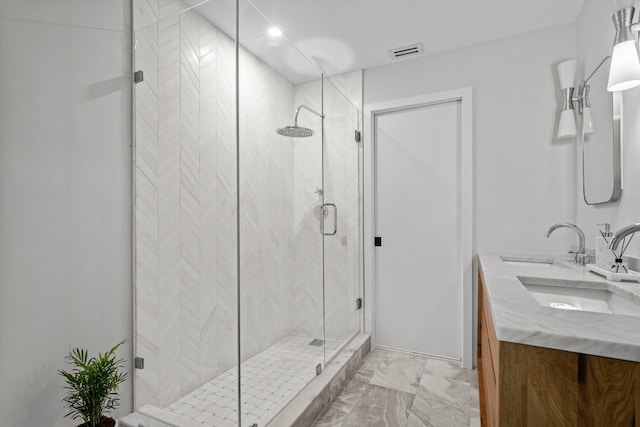 bathroom featuring an enclosed shower and vanity