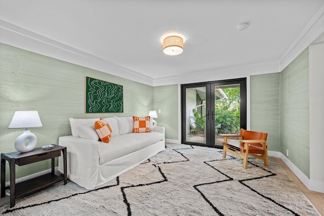 living room featuring light wood-type flooring, crown molding, and french doors