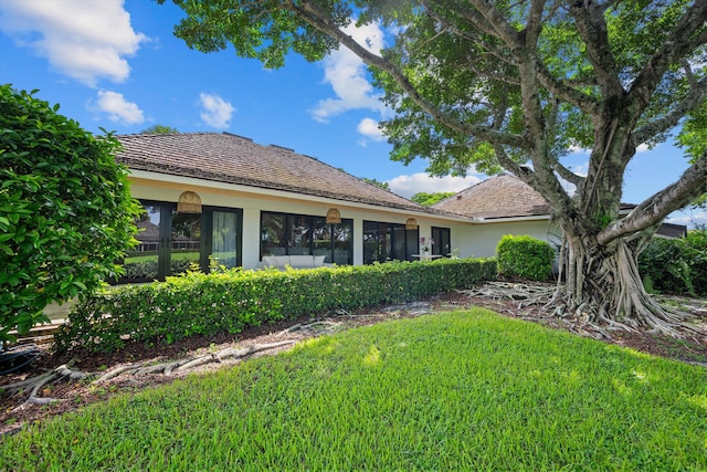 rear view of house with a lawn