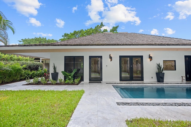 rear view of property featuring french doors and a patio