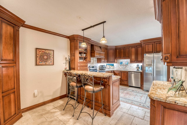 kitchen with stainless steel appliances, light stone counters, premium range hood, and kitchen peninsula