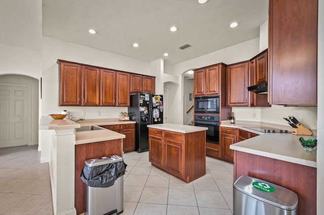 kitchen featuring a kitchen island, sink, black appliances, and light tile patterned floors