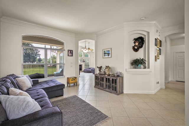 tiled living room with a chandelier and crown molding