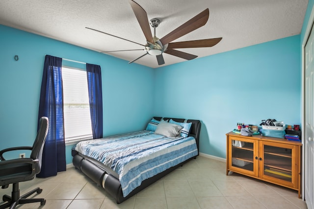 bedroom featuring light tile patterned floors, a textured ceiling, and ceiling fan