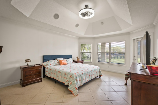 tiled bedroom featuring a raised ceiling and ornamental molding