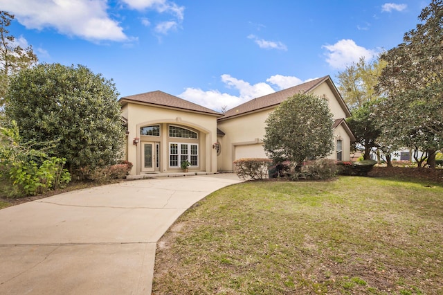 mediterranean / spanish house with a front yard