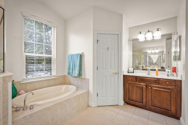 bathroom featuring vaulted ceiling, vanity, tiled bath, and tile patterned floors