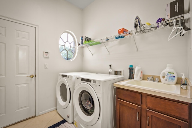 laundry room featuring light tile patterned flooring, washer and clothes dryer, sink, and cabinets