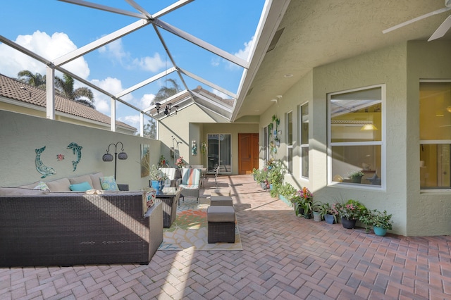 sunroom featuring ceiling fan