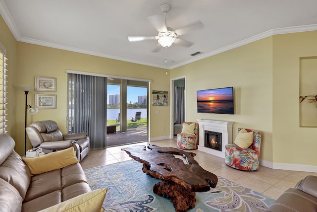 living room with light tile flooring, a water view, ornamental molding, and ceiling fan