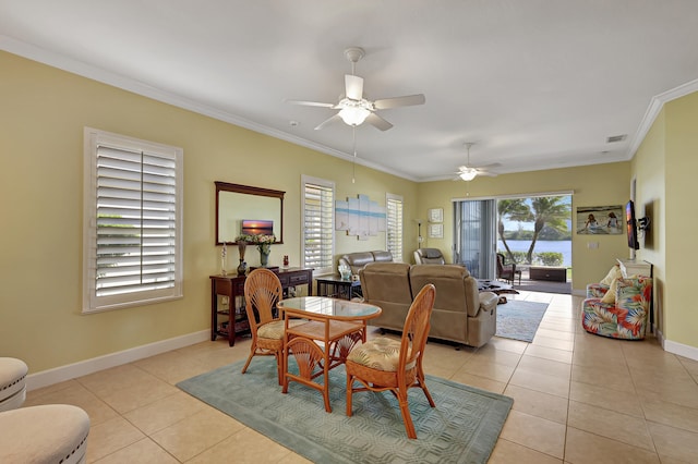 tiled dining area featuring ornamental molding and ceiling fan