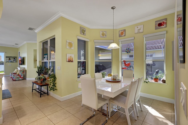 dining space featuring ornamental molding and light tile flooring