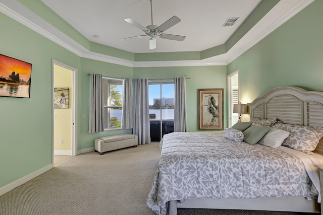 carpeted bedroom featuring crown molding, a raised ceiling, and ceiling fan