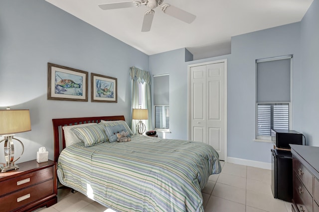 tiled bedroom with a closet and ceiling fan