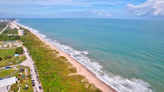 birds eye view of property featuring a beach view and a water view