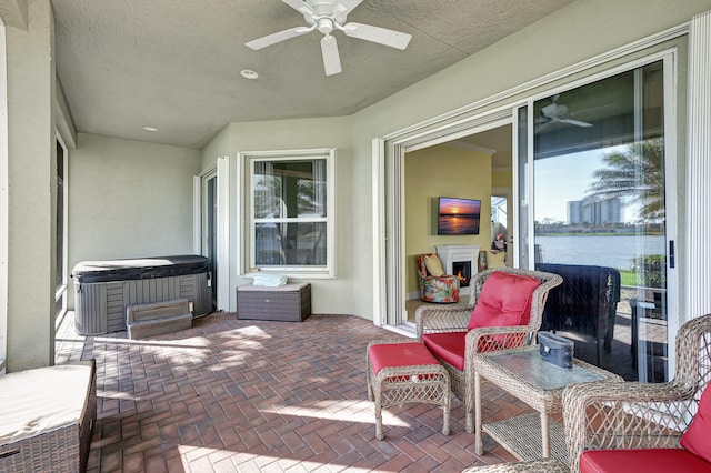 view of patio / terrace featuring ceiling fan and a water view