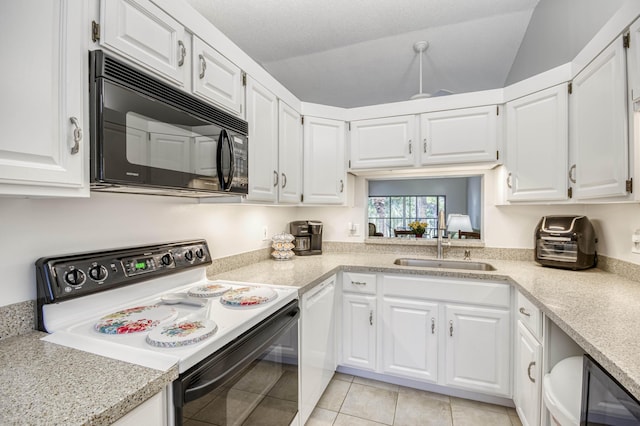 kitchen with electric range oven, black microwave, a sink, light countertops, and vaulted ceiling
