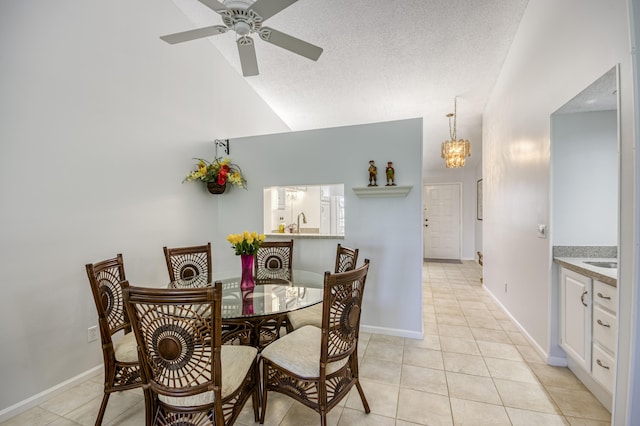 dining space with light tile patterned flooring, a ceiling fan, high vaulted ceiling, baseboards, and a chandelier